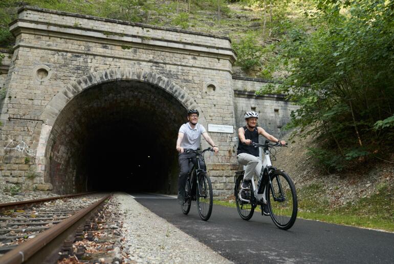 Radfahrer kommen aus einem Tunnel auf dem Kanonenbahnradweg